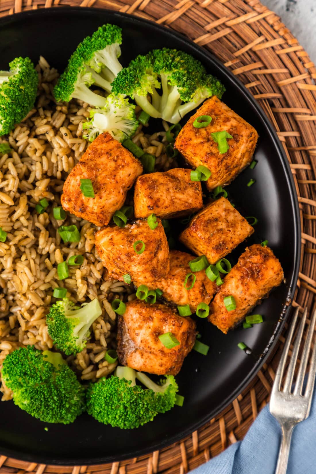 Close up photo of Air Fryer Salmon Bites plated with broccoli and rice