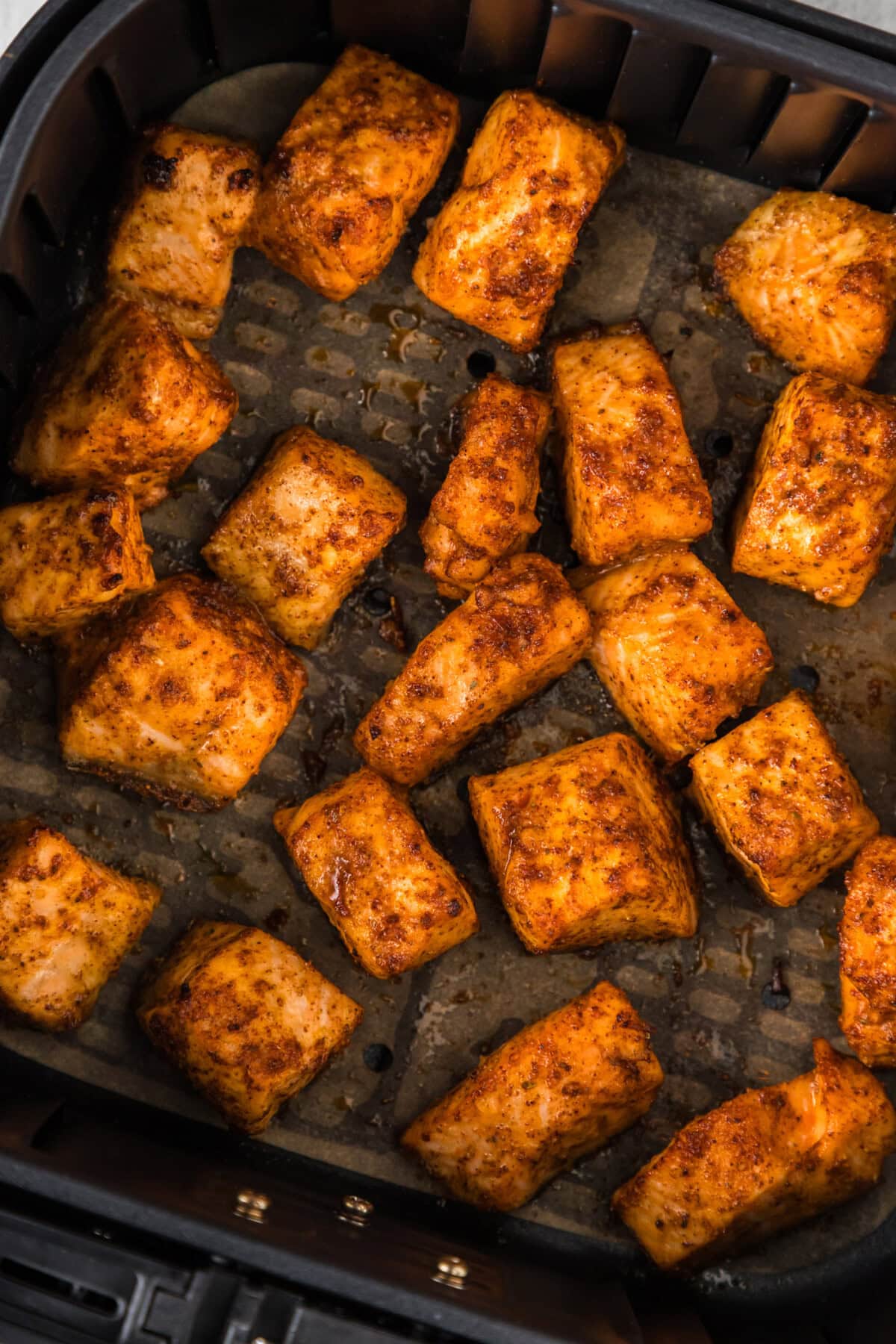 Close up photo of Air Fryer Salmon Bites in an air fryer