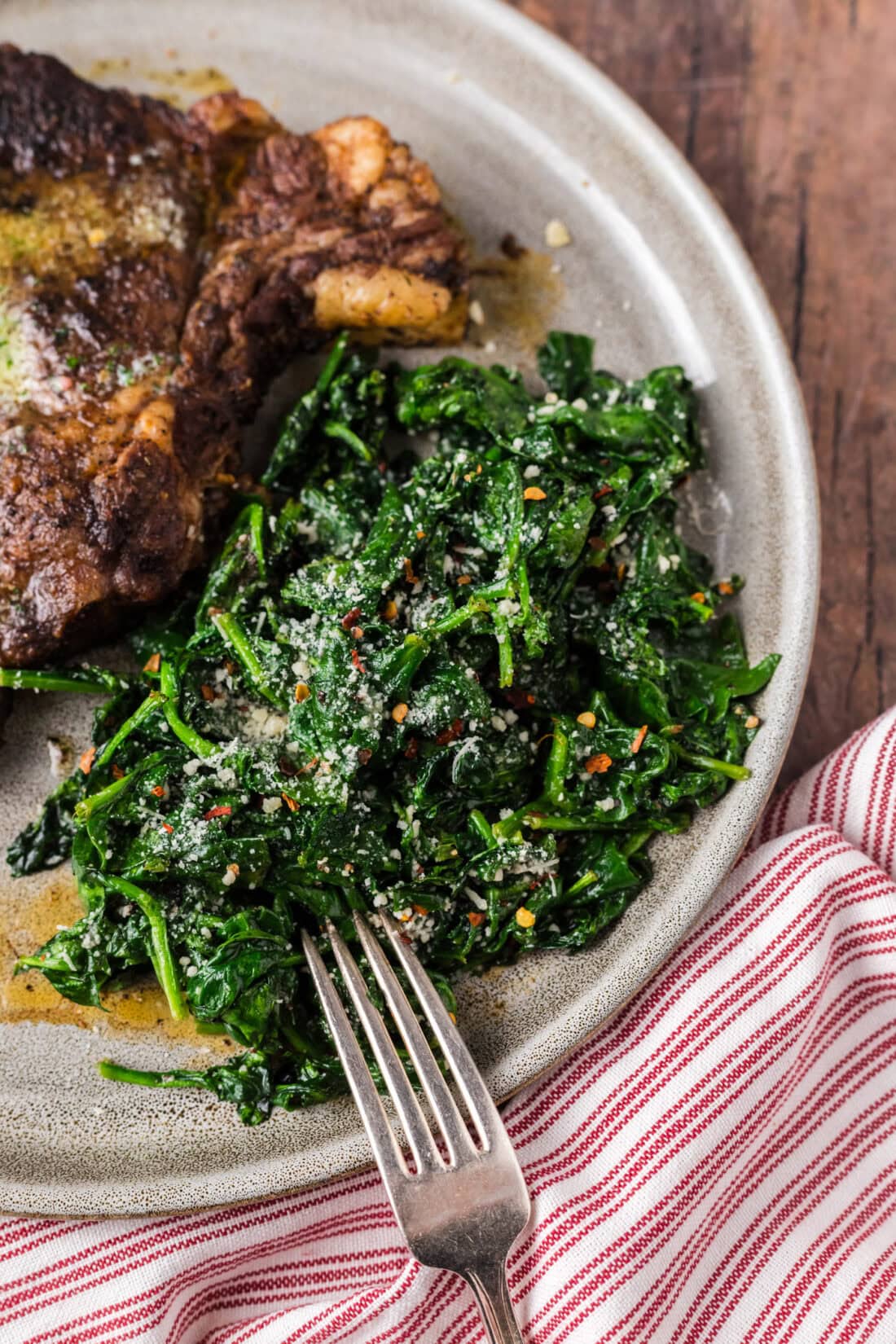 Air Fryer Spinach on a plate with a fork to the side