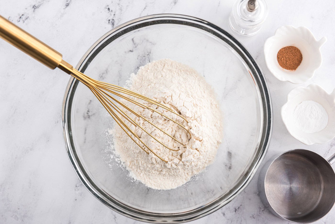 flour and dry ingredients with a whisk in a bowl