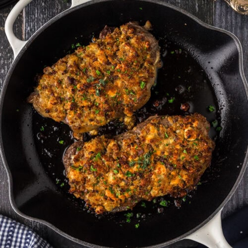 Two Blue Cheese Crusted Steaks in a skillet
