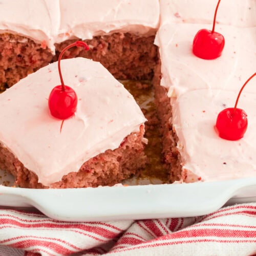 Slice of Cherry Cake with Cherry Frosting in a 13x9 pan