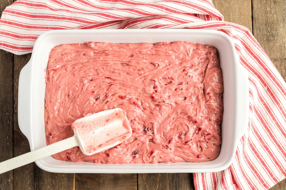 cherry cake batter in a 13x9 pan