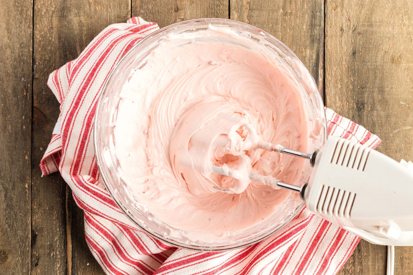 cherry frosting in a mixer bowl