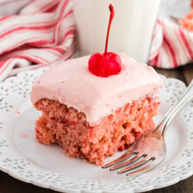 slice of cherry cake on plate with a fork