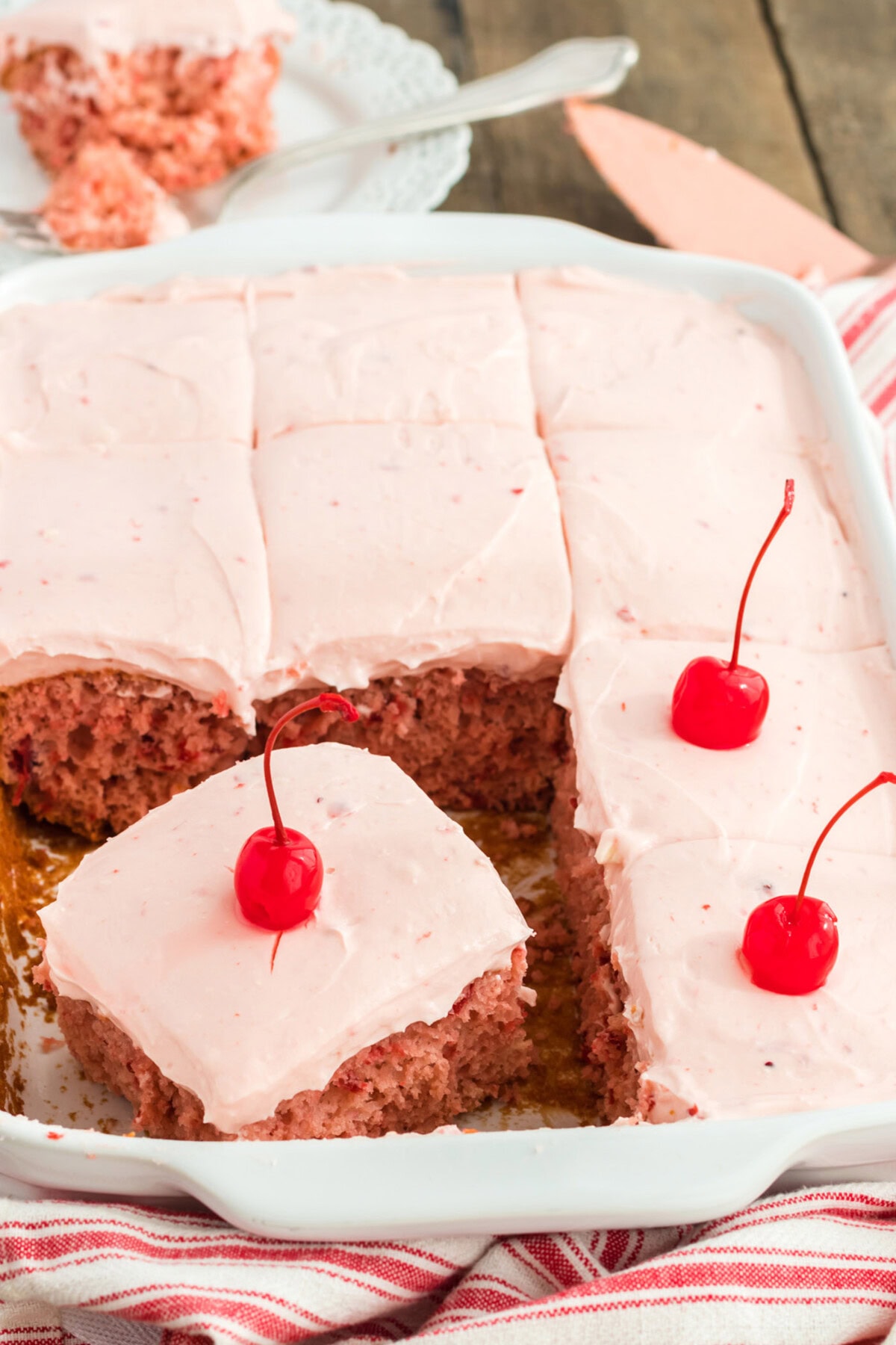 pan of cherry cake topped with maraschino cherries
