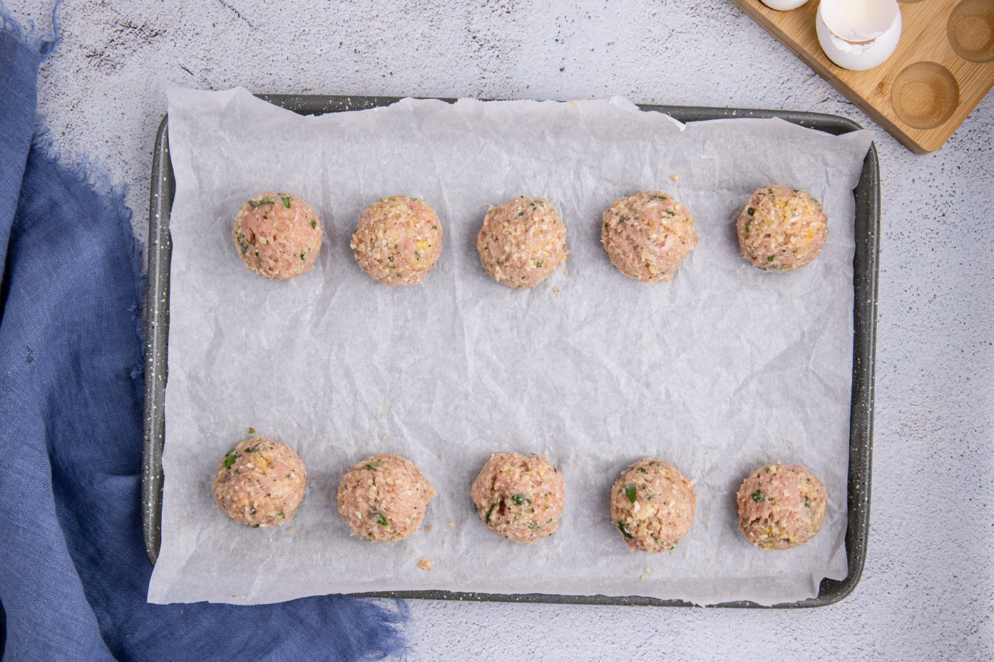 chicken meatballs on a parchment lined baking sheet