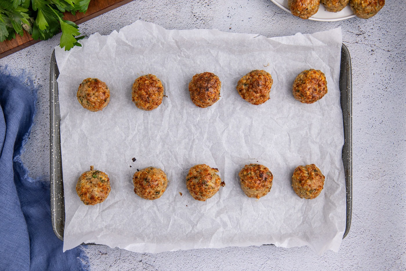 baked chicken meatballs on parchment paper