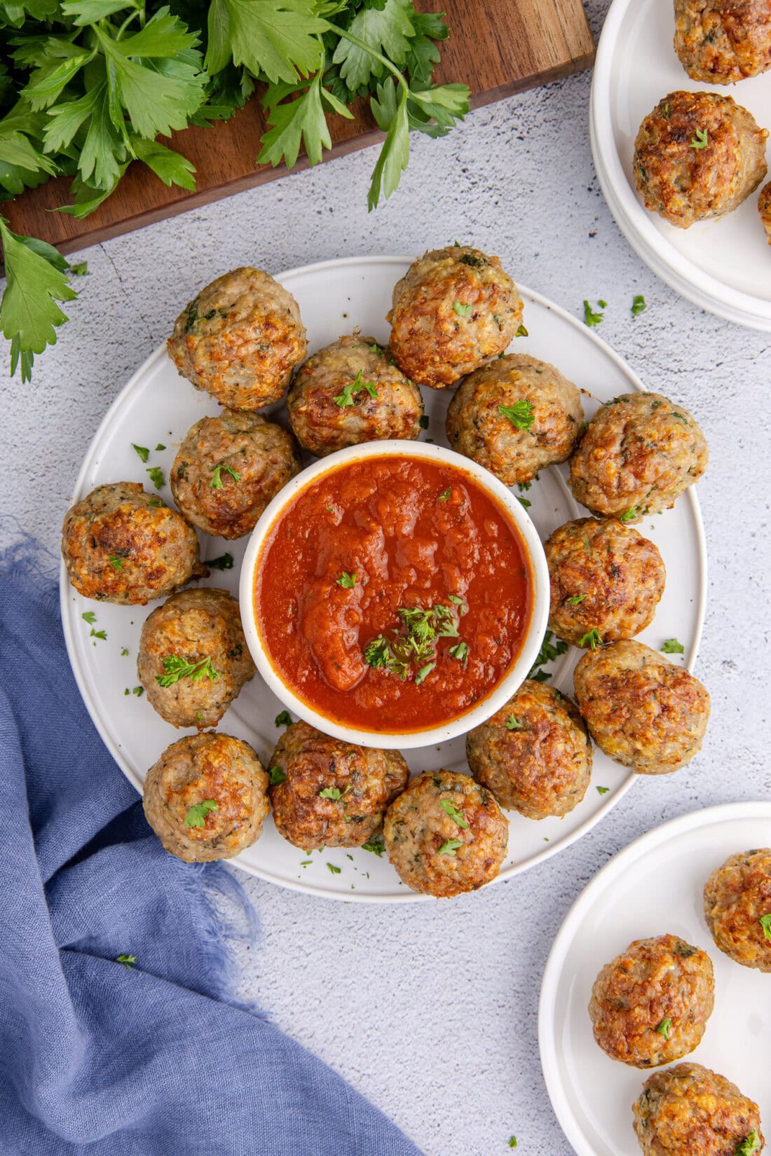 Plate of Chicken Meatballs with a bowl of marinara sauce 