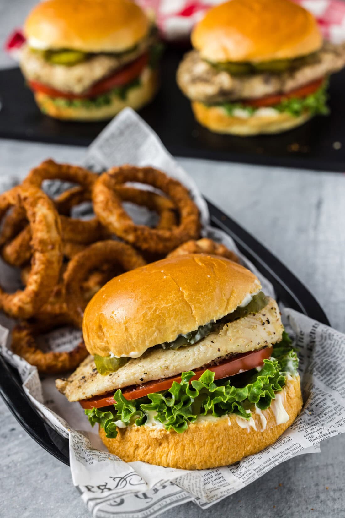 Chicken Sandwich in a basket with onion rings