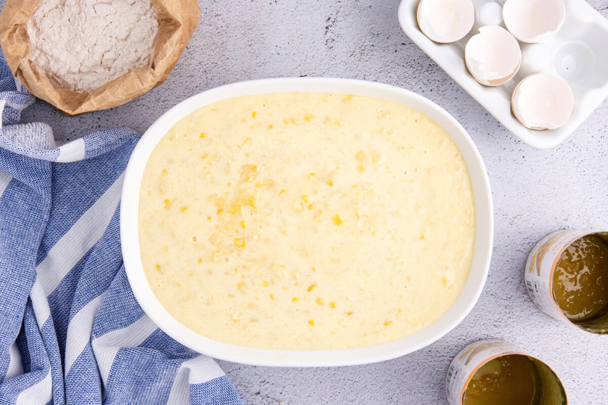 overhead shot of corn pudding in an oval baking dish