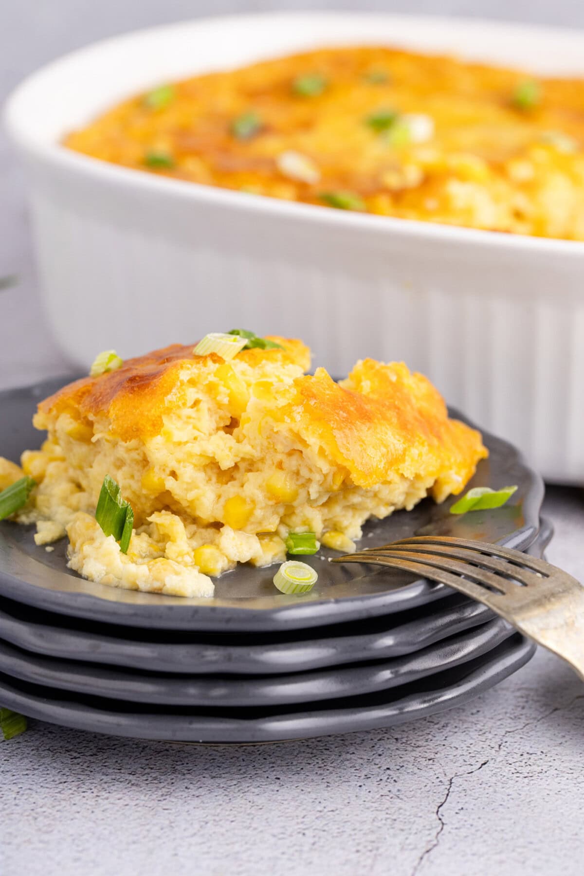 Corn Pudding on a plate with a fork