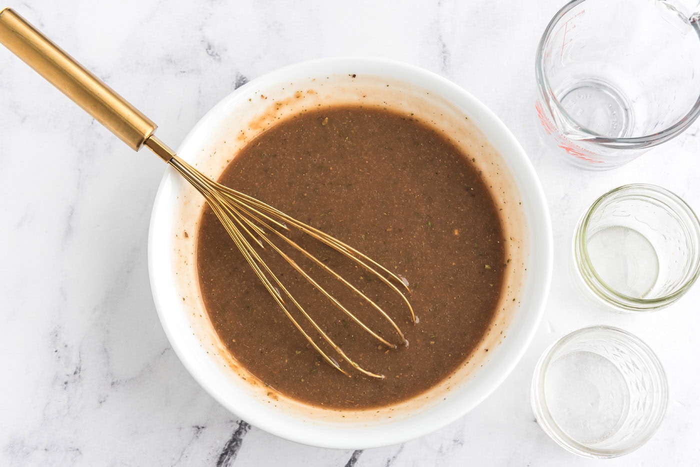 gravy mixture in a bowl with a whisk