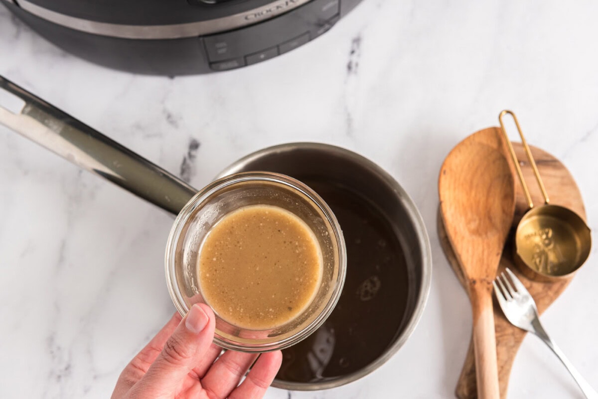 adding cornstarch mix to pan juices to make gravy