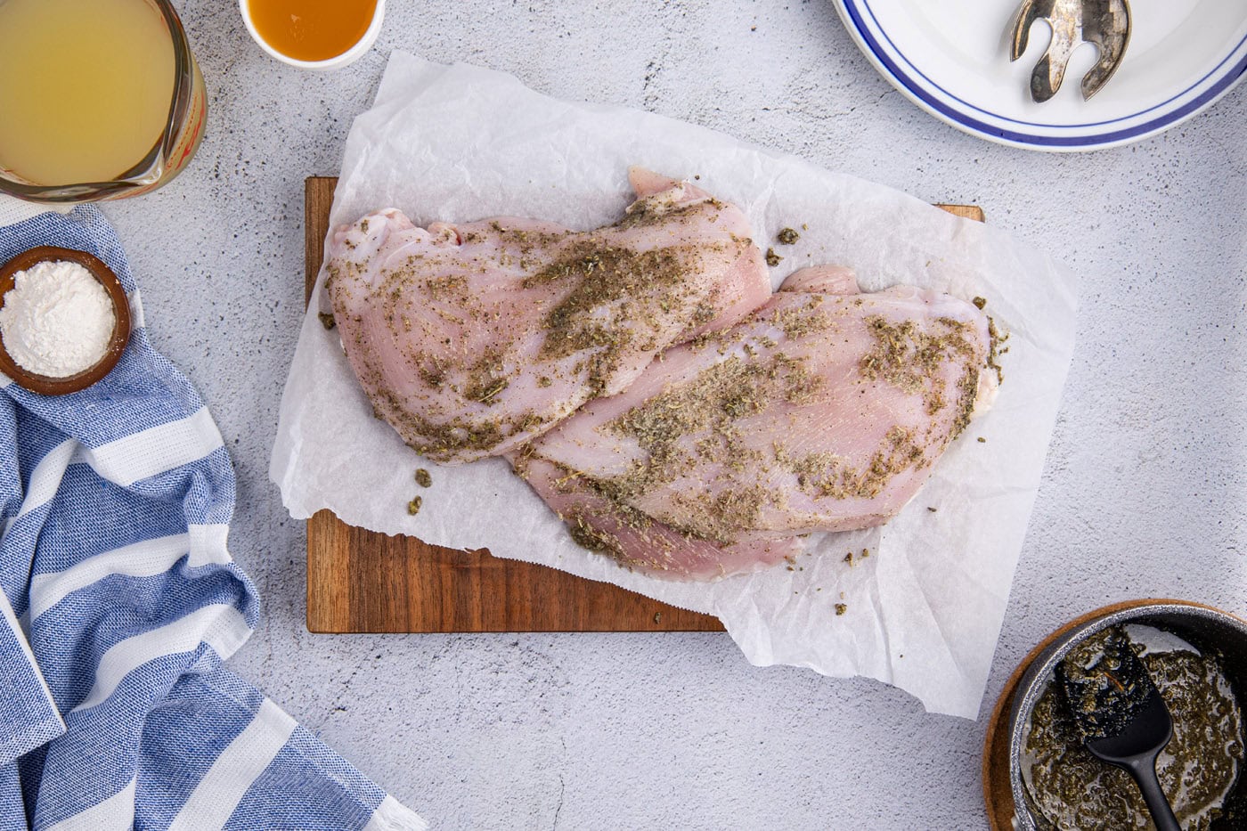 turkey breasts rubbed with seasonings on a cutting board