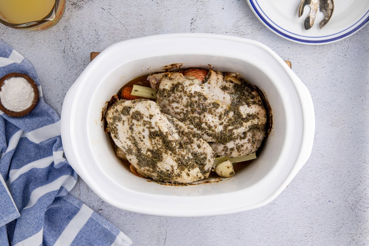 cooked turkey breast in a slow cooker crock