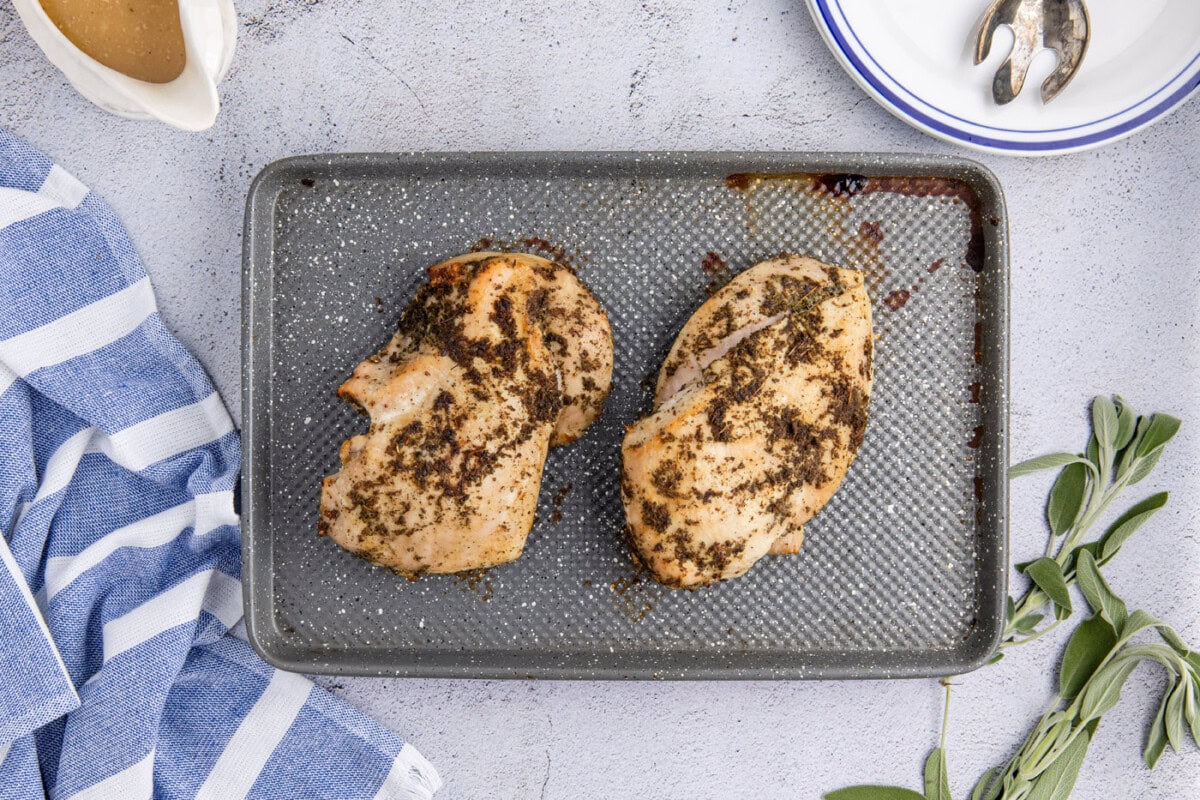 turkey breasts resting on a baking sheet