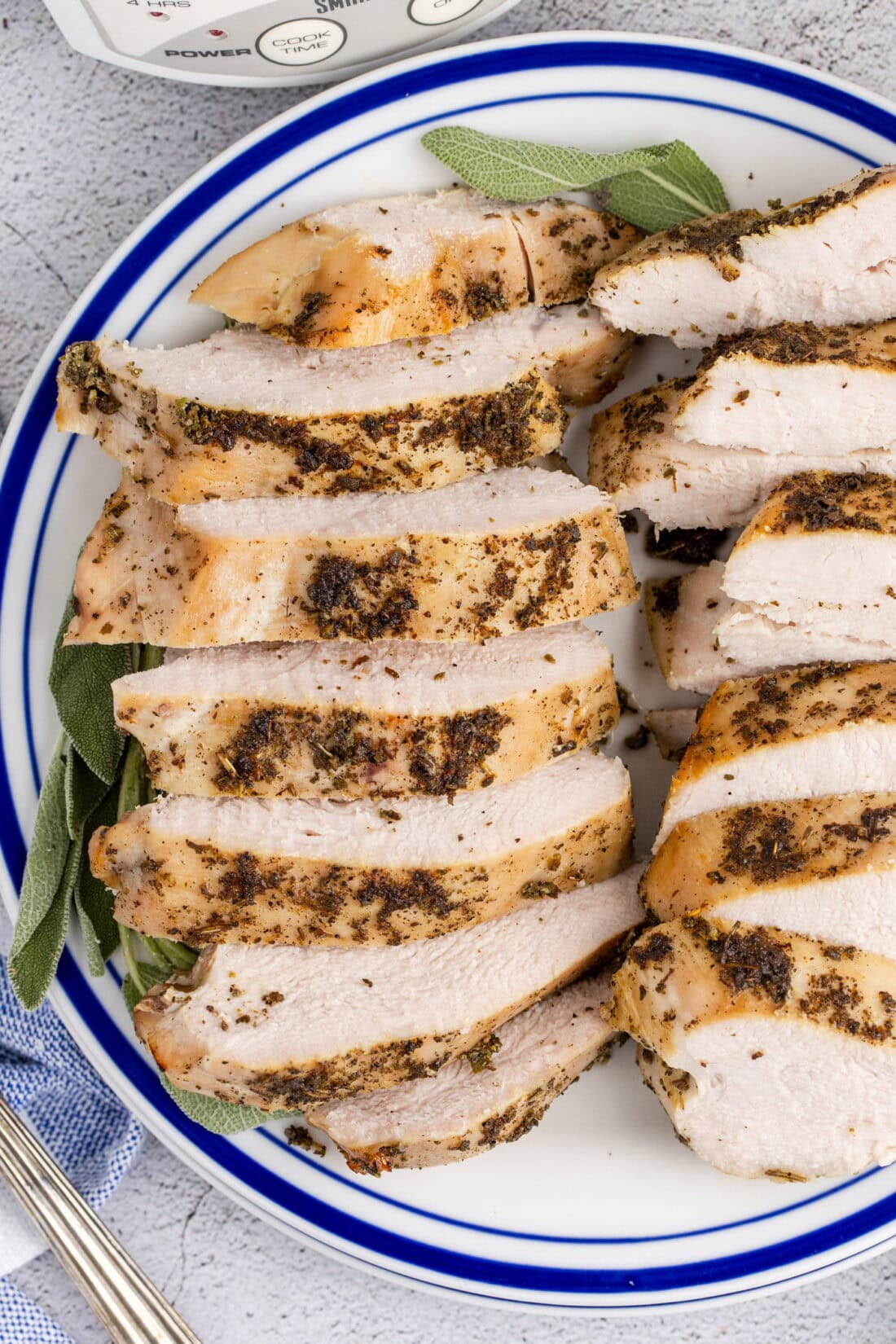 Close up photo of Crockpot Turkey Breast on a plate cut into slices