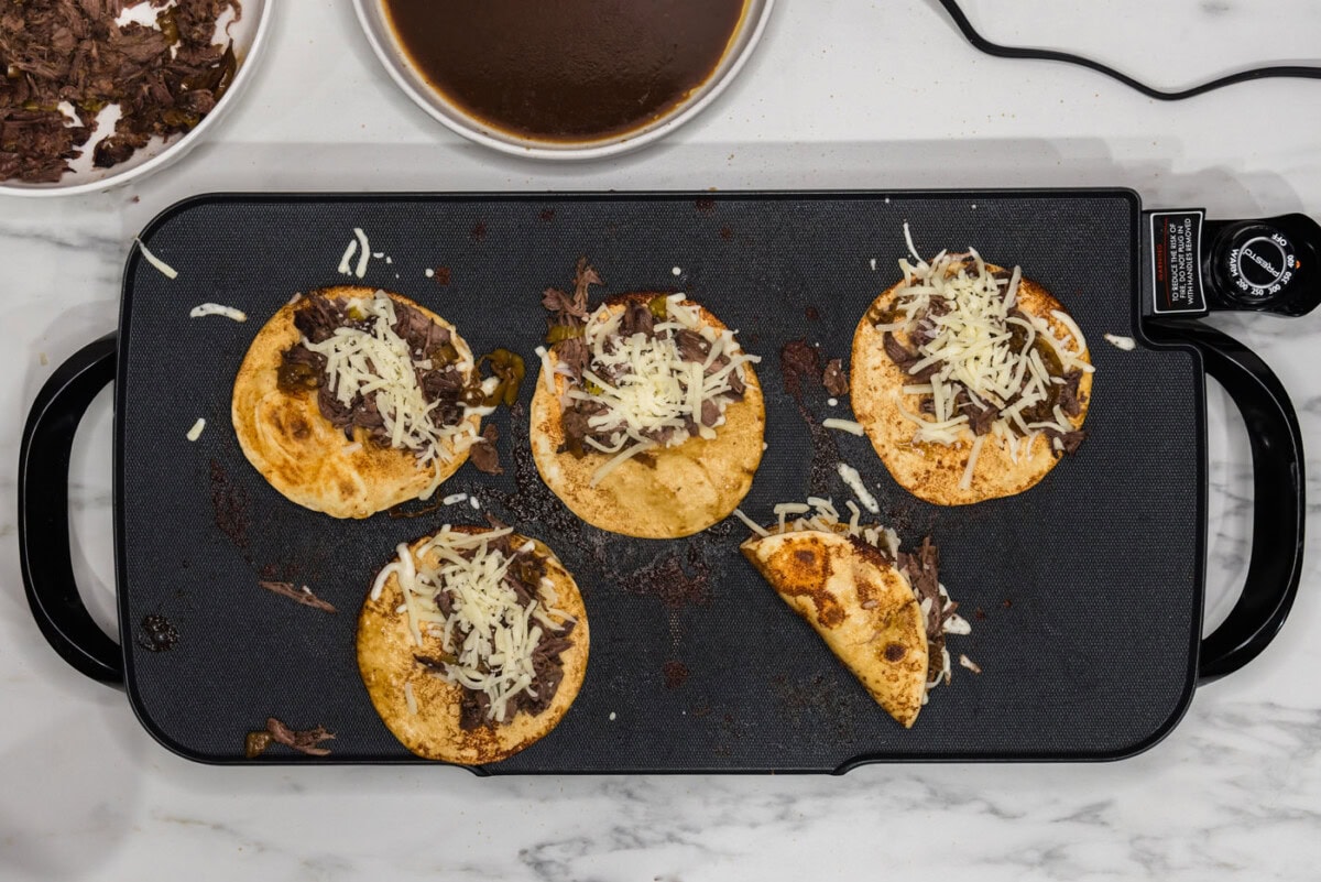 folding mississippi pot roast tacos inside a crisped tortilla