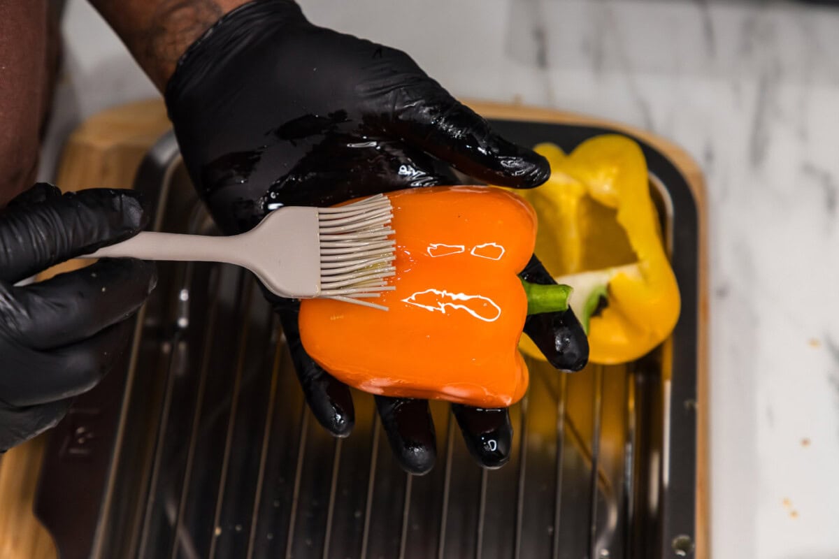 brushing bell pepper halves with olive oil