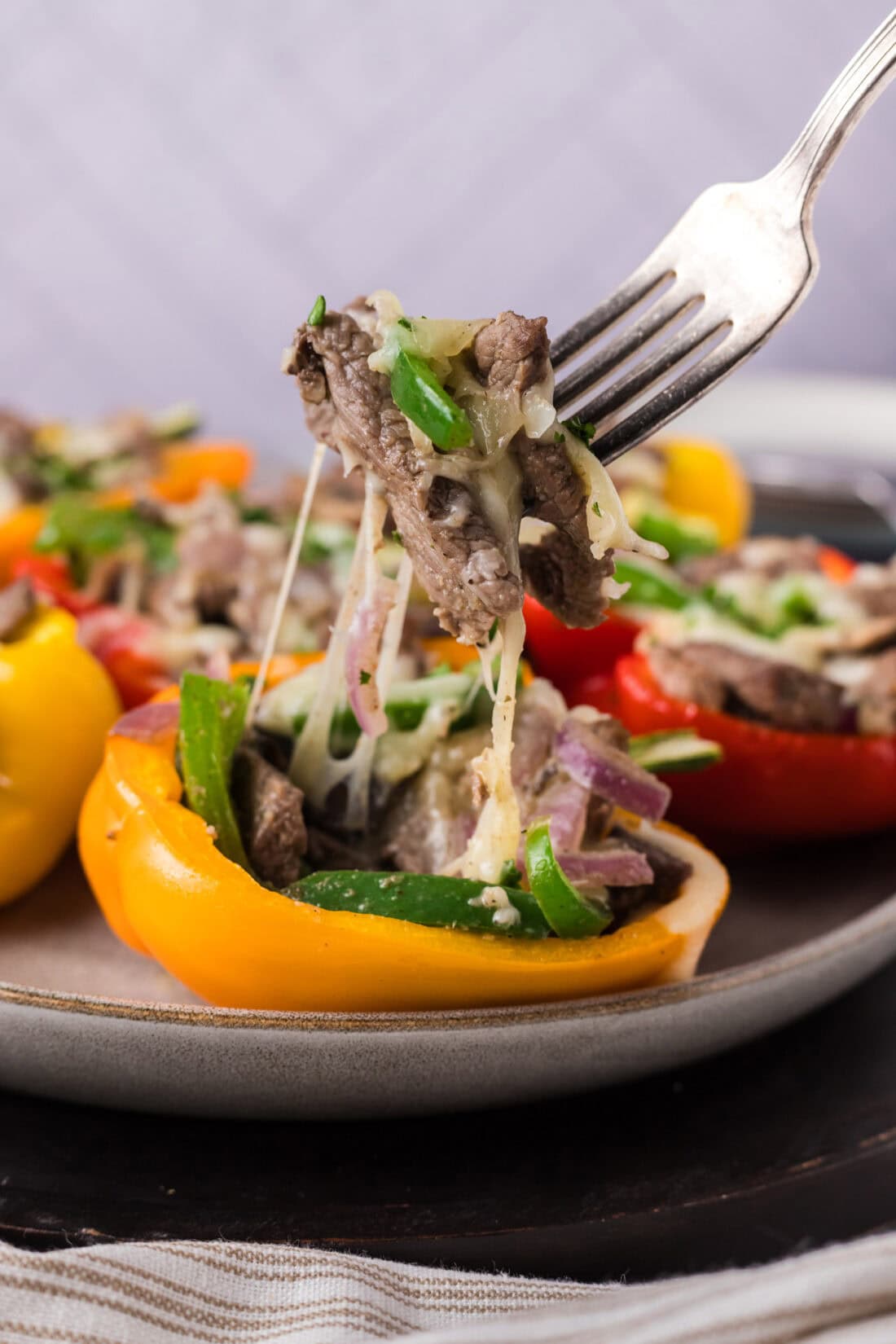 Fork pulling up pieces of Philly Cheesesteak Stuffed Peppers