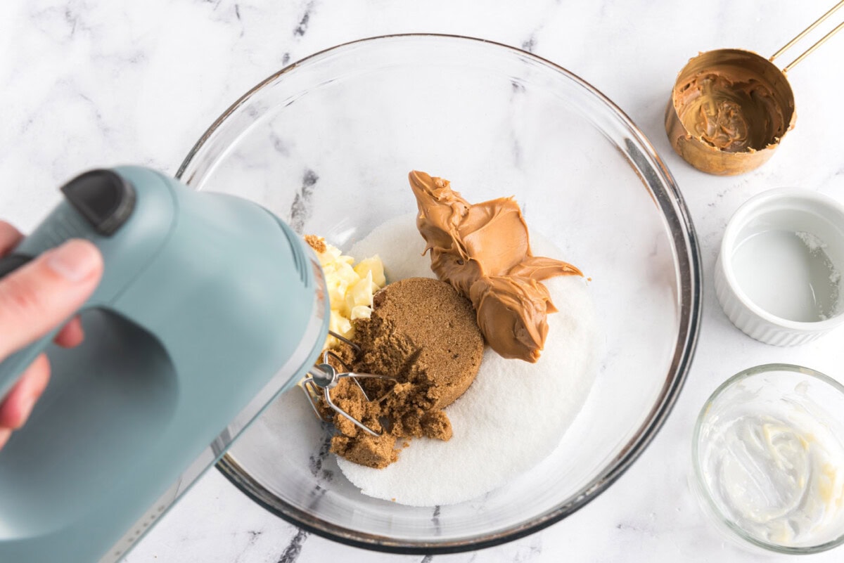peanut butter, sugar, brown sugar, and butter in a mixer bowl