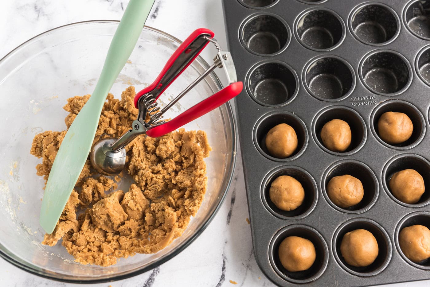 scooping 1 inch dough balls into a mini muffin pan