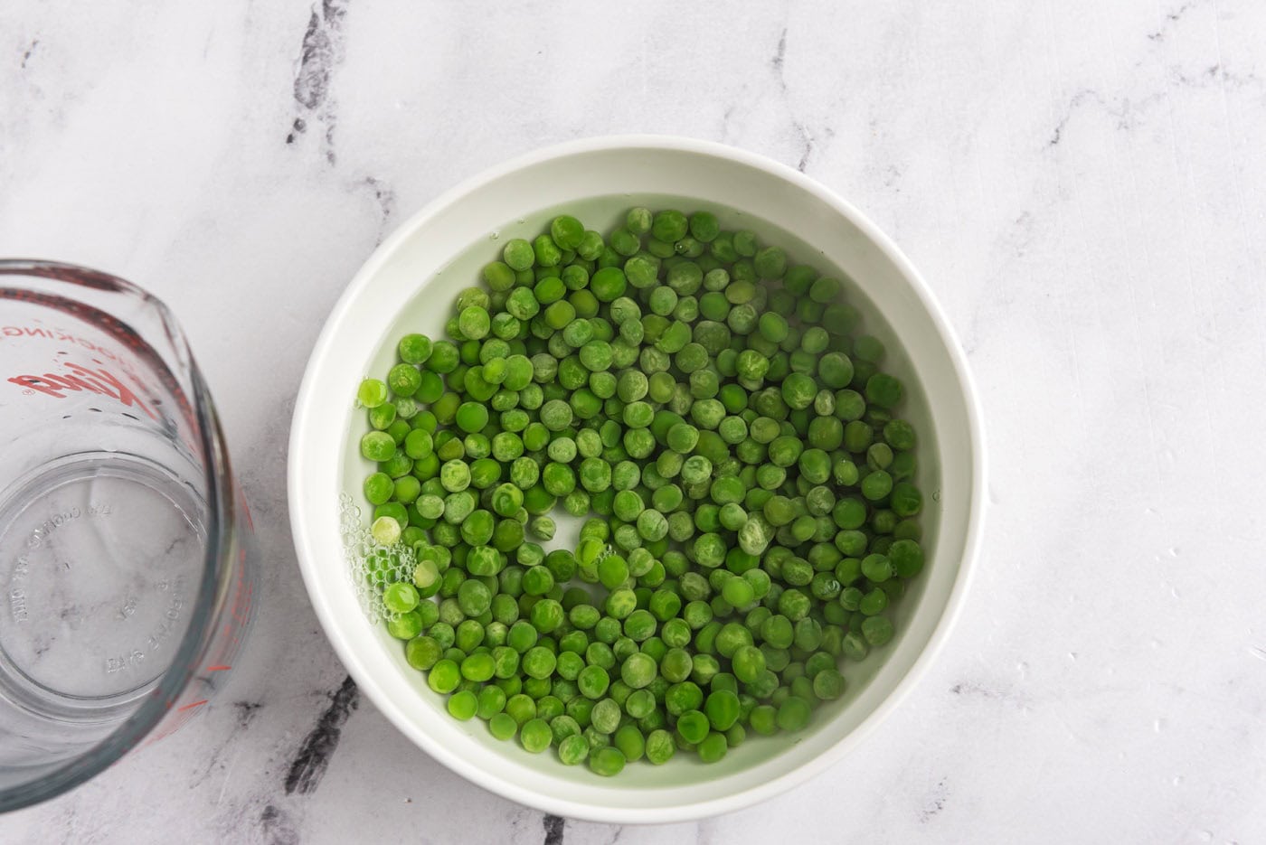 peas in a bowl with hot water