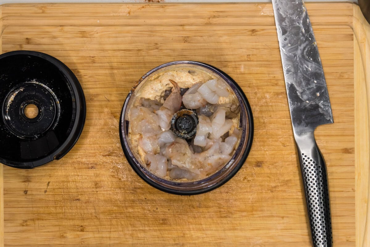 shrimp added to burger ingredients in a mini chopper