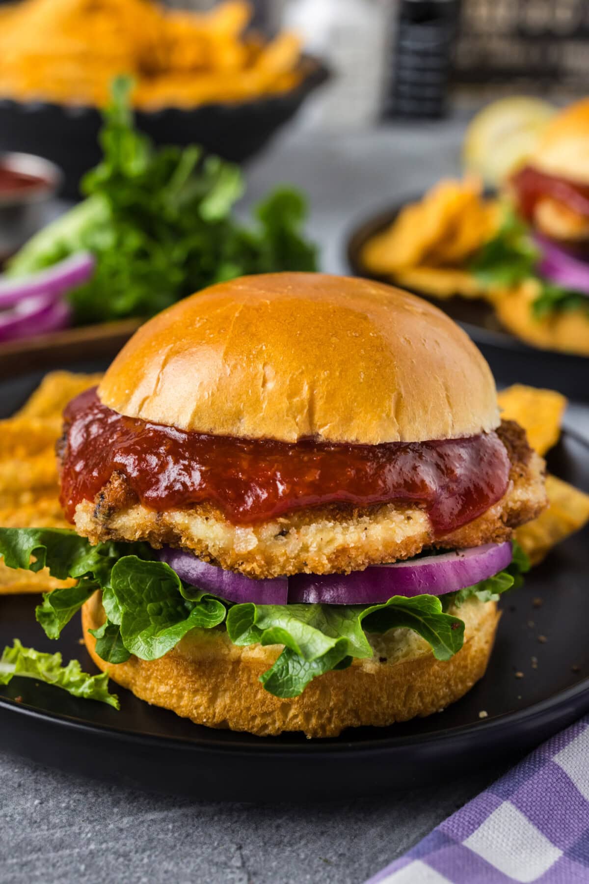 Shrimp Burger on a plate with another burger in the background