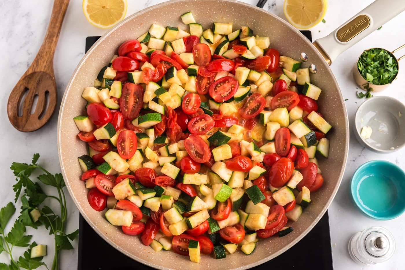 cooked zucchini and tomatoes in a skillet