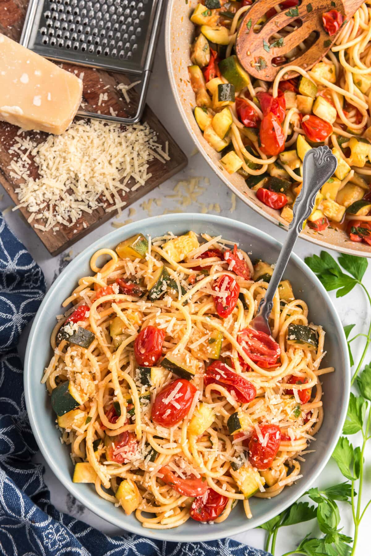 Bowl of Simple Zucchini Tomato Pasta topped with parmesan 