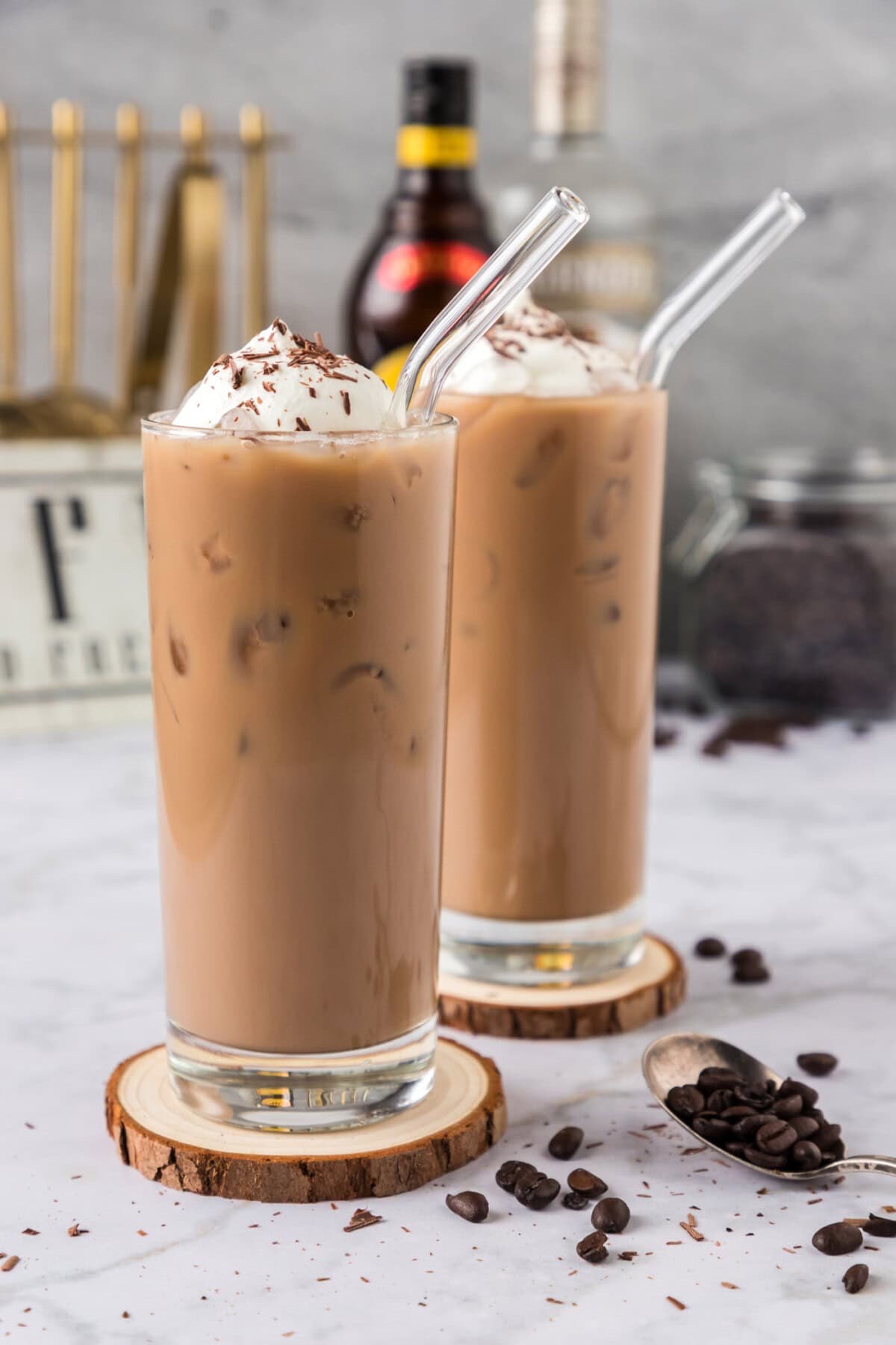 Two Spiked Iced Coffees on wooden coasters