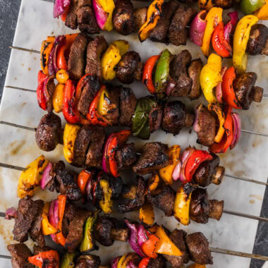 Close up photo of Steak Kabobs on a marble platter