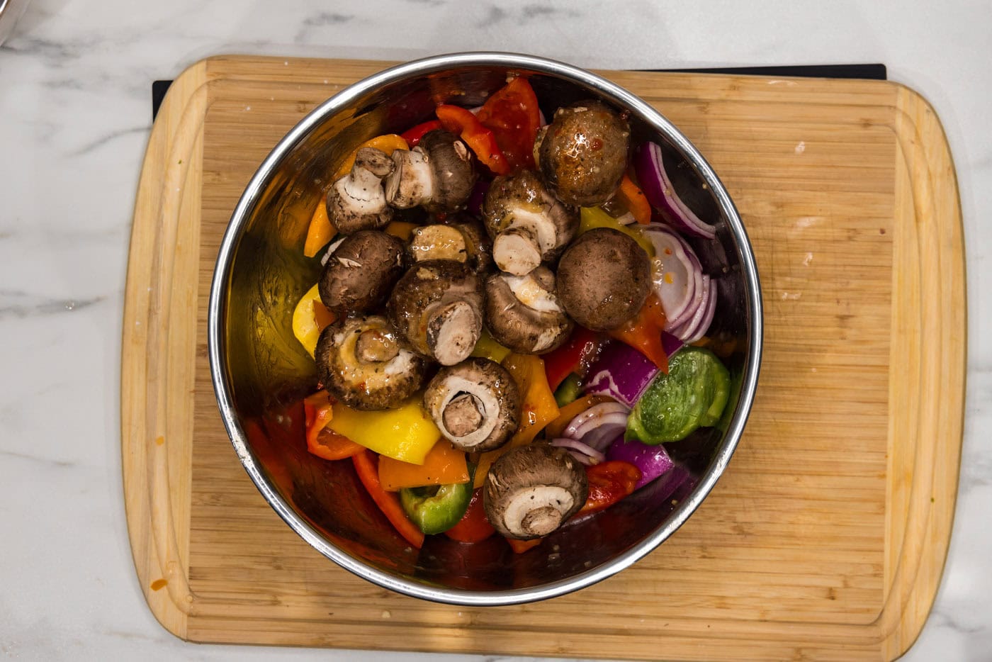 bowl of sliced bell peppers, onions, and mushrooms