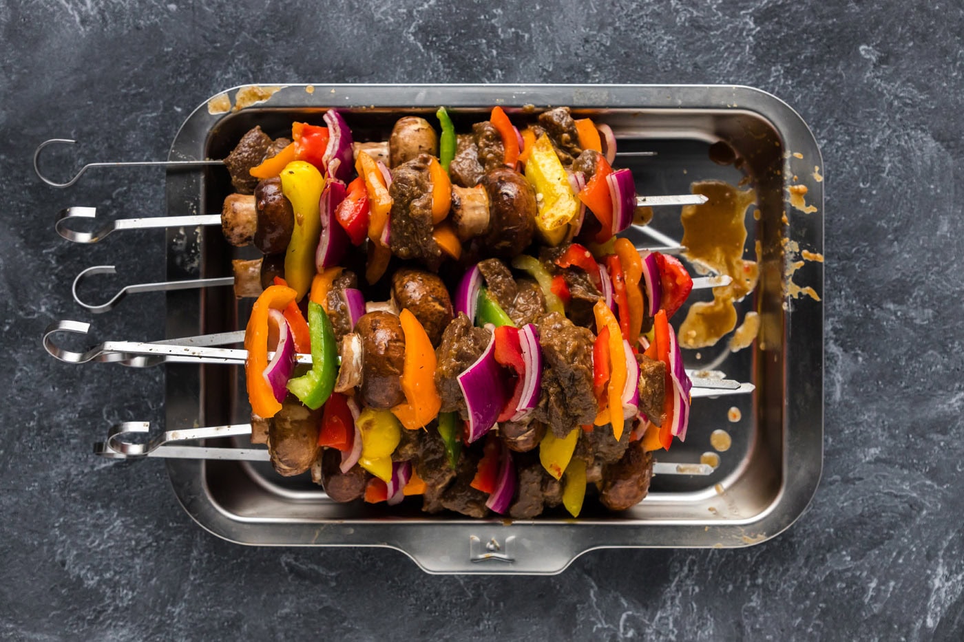 steak kabobs skewered with bell peppers, onions, and mushrooms