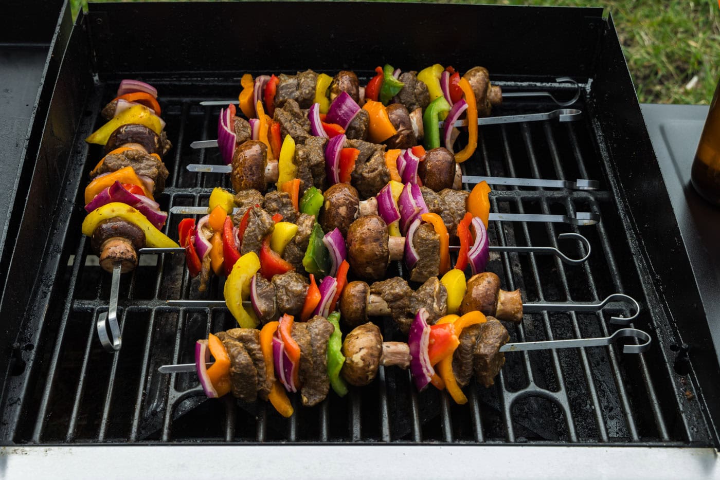 steak kabobs with vegetables on grill grates