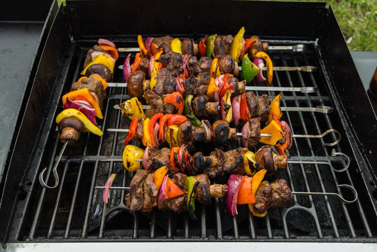 cooked steak kabobs on grill grates
