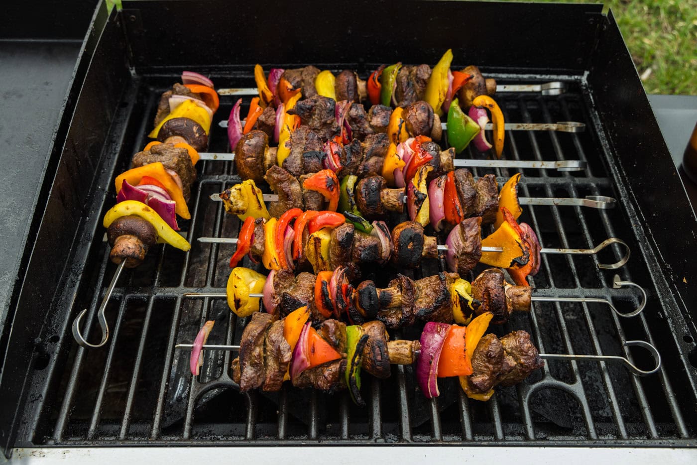 cooked steak kabobs on grill grates