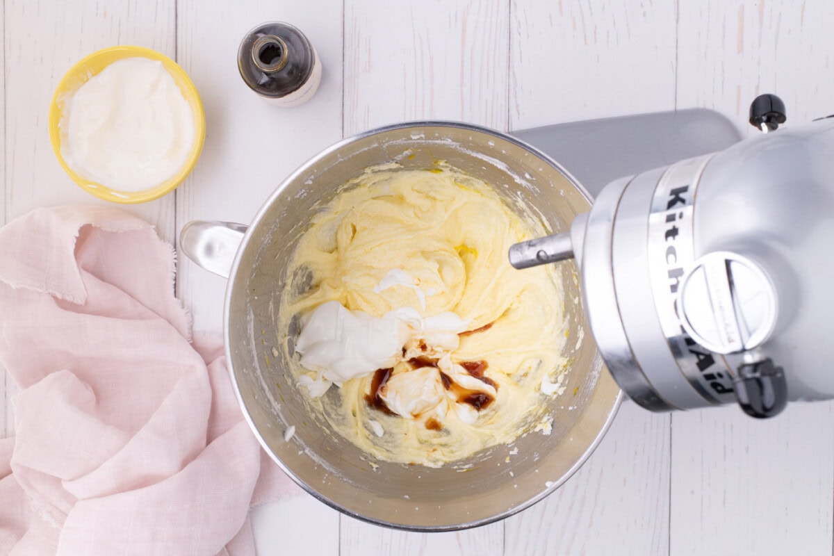 adding vanilla and sour cream added to creamed butter and sugar mixture in a stand mixer