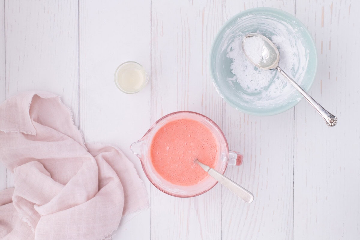 easy strawberry glaze in a measuring cup