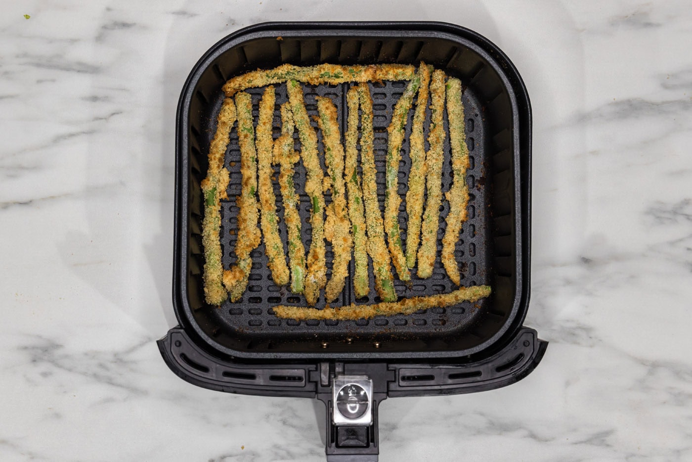 fried asparagus in air fryer basket