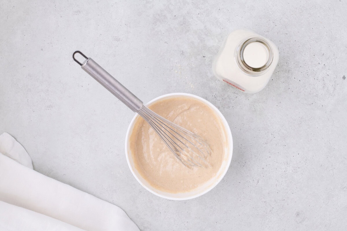 pancake batter mixed in a bowl with a whisk