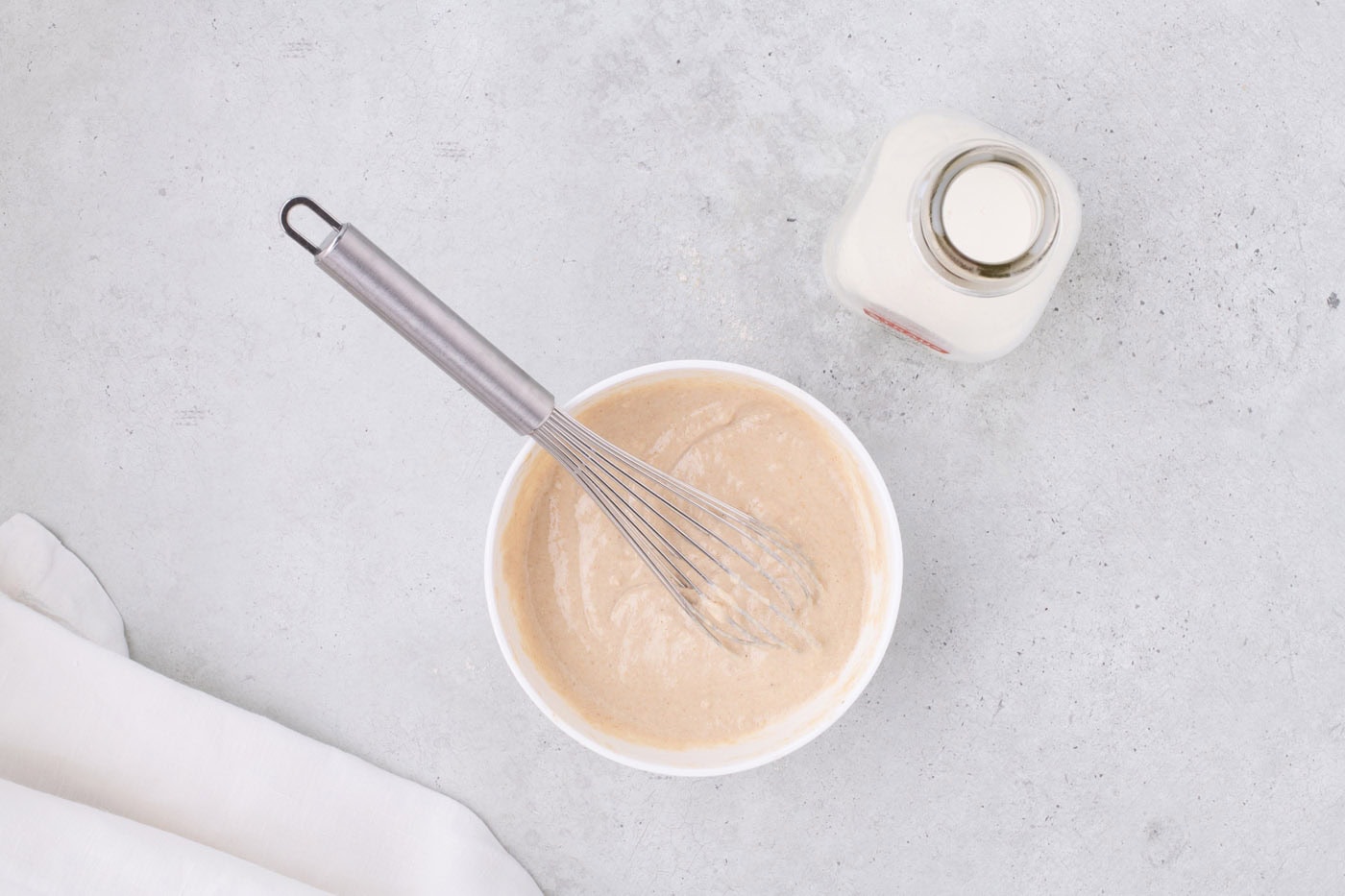 pancake batter mixed in a bowl with a whisk