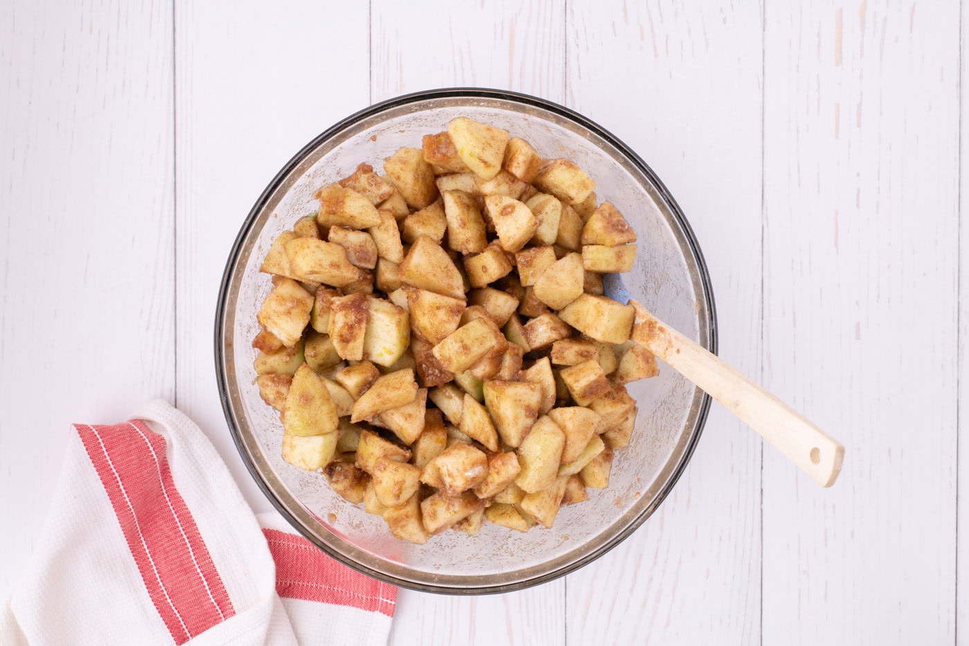 chopped apples coated in spices for pie filling in a bowl