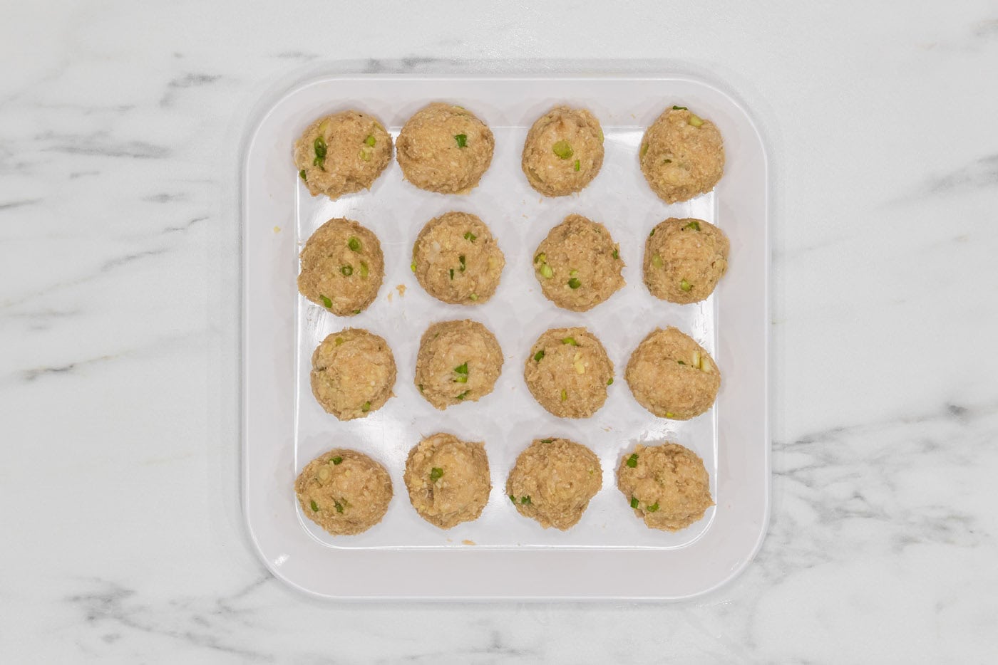 Asian inspired chicken meatballs in a tray