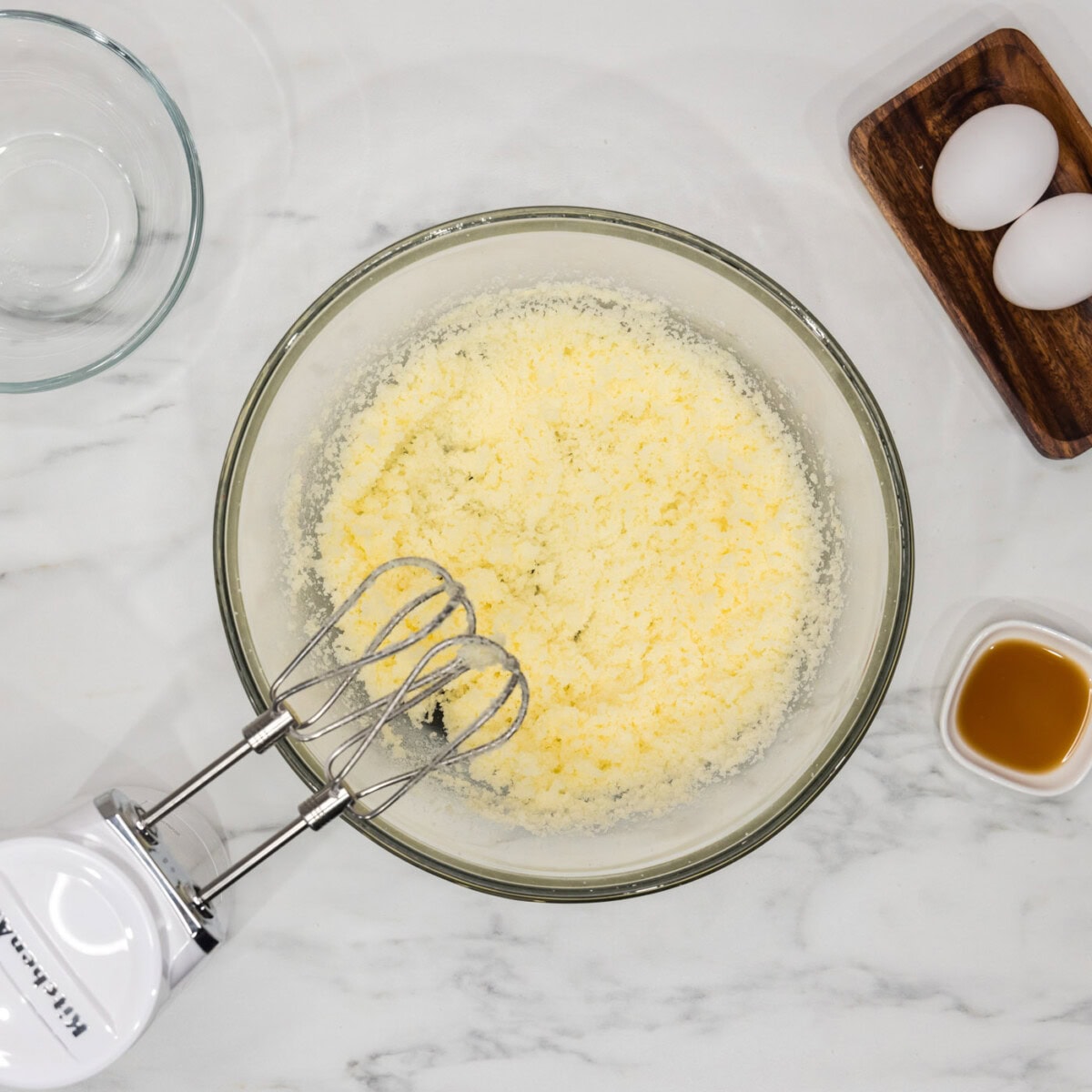 shortening and sugar creamed in a bowl with a hand mixer