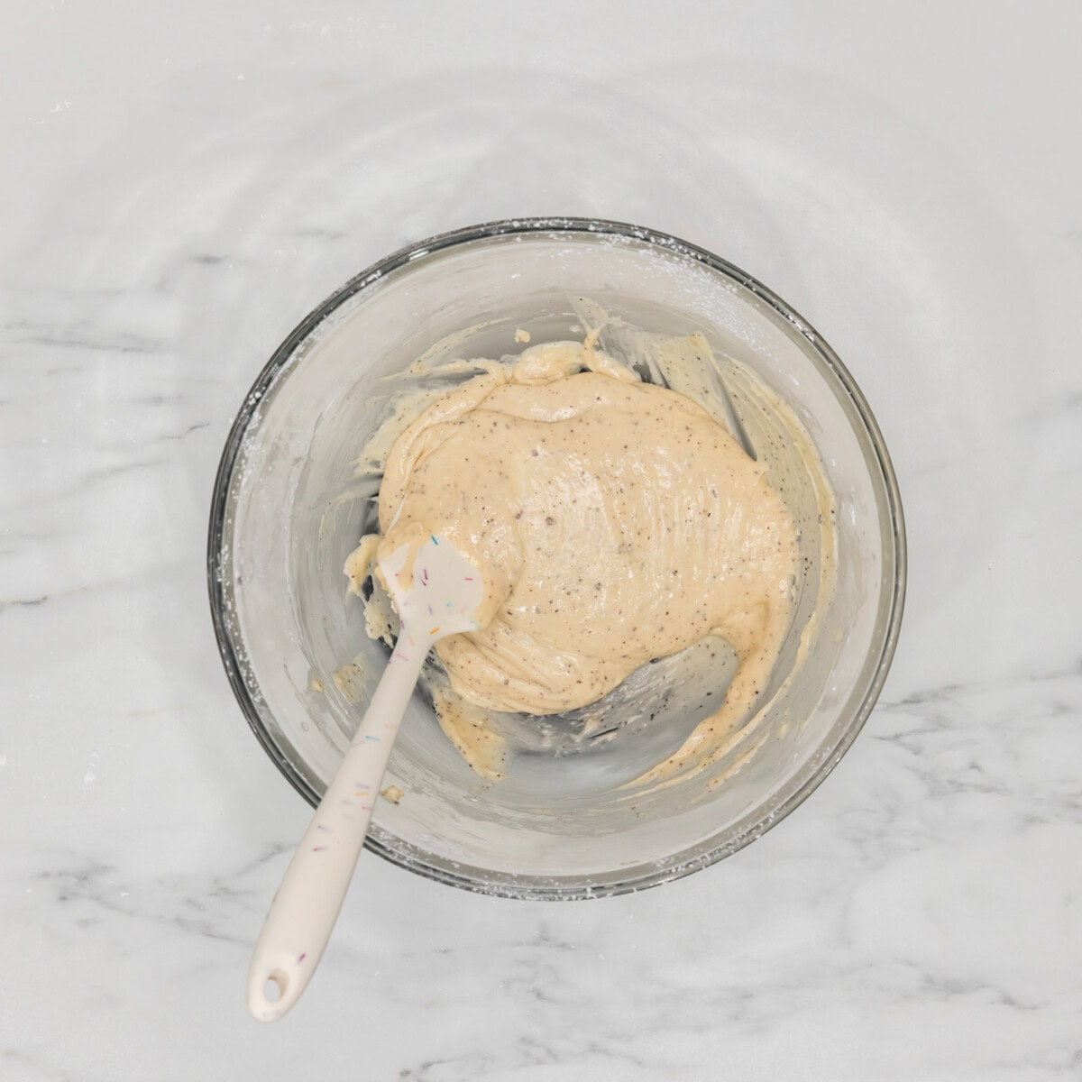 brown butter glaze in a bowl with a rubber spatula