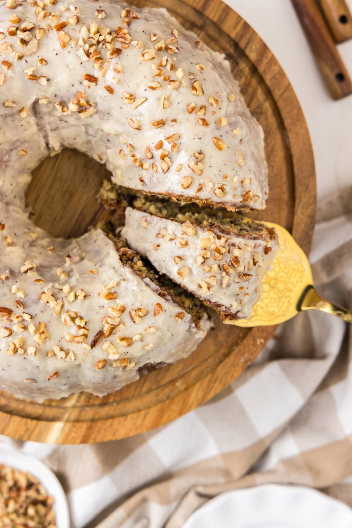Overhead photo of a Banana Bundt Cake with a slice being removed