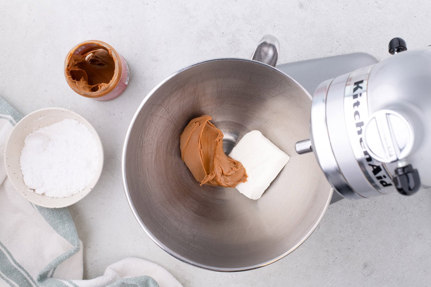 cookie butter and cream cheese in a stand mixer bowl